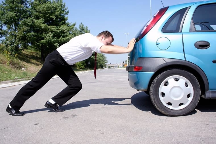 man pushing car - bad choices